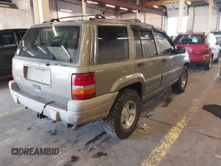 1996 Jeep Grand Cherokee Laredo with VIN 1J4GZ58S9TC293787, listed as a IAAI auction lot 41179368 with 141,755 mi miles. Bid and sale history available at carsss.com. Image 4.