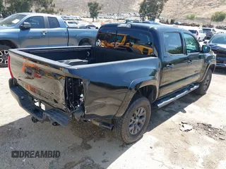 2023 Toyota Tacoma SR with VIN 3TMCZ5AN1PM654572, listed as a IAAI auction lot 42312575 with 14,111 mi miles and . Bid and sale history available at DreamBid. Image 4.