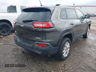 2014 Jeep Cherokee Altitude with VIN 1C4PJMCB7EW232678, listed as a IAAI auction lot 40812147 with 105,828 mi miles. Bid and sale history available at carsss.com. Image 4.