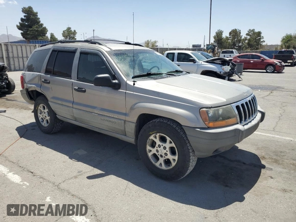 1999 Jeep Grand Cherokee Laredo with VIN 1J4GW58S1XC775877, listed as a Copart auction lot 55639795 with 197,611 mi miles and Salvage title. Bid and sale history available at DreamBid. Image 4.