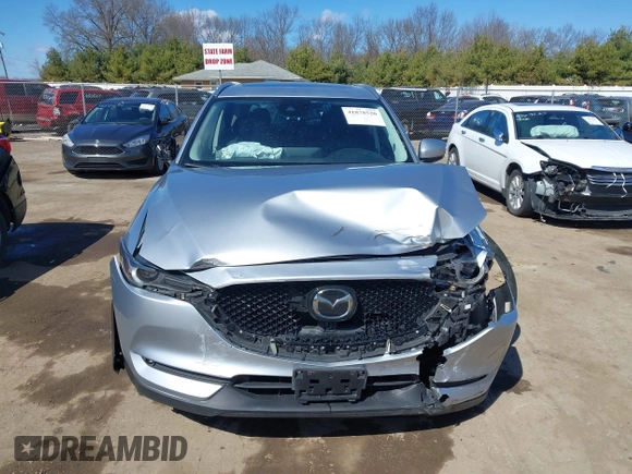 2021 Mazda CX-5 Grand Touring with VIN JM3KFBDM3M1300316, listed as a IAAI auction lot 41878520 with 77,670 mi miles and . Bid and sale history available at DreamBid. Image 12.
