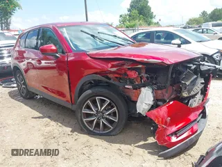 2018 Mazda CX-5 Grand Touring z VIN JM3KFADM4J0335913, wystawiony jako IAAI lot #42326044 z przebiegiem 104 583 mil mil oraz . Historia ofert i sprzedaży dostępna na DreamBid. Obrazek 1.