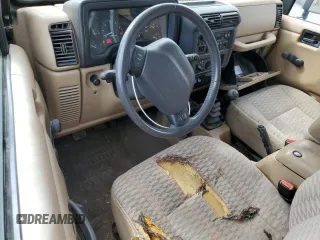 2000 Jeep Wrangler Sport z VIN 1J4FA49S9YP798353, wystawiony jako Copart lot #62009645 z przebiegiem 116 676 mil mil oraz Szkoda całkowita • Salvage title. Historia ofert i sprzedaży dostępna na DreamBid. Obrazek 8.