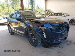 2018 Mazda CX-5 Grand Touring z VIN JM3KFBDM9J0410059, wystawiony jako IAAI lot #42366102 z przebiegiem 69 470 mil mil oraz . Historia ofert i sprzedaży dostępna na DreamBid. Obrazek 1.