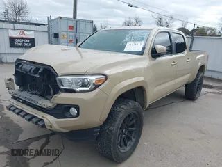 2016 Toyota Tacoma SR5 with VIN 3TMDZ5BN3GM003351, listed as a IAAI auction lot 41721932 with 100,774 mi miles and . Bid and sale history available at DreamBid. Image 2.