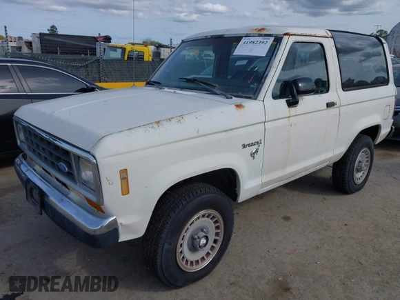 1986 Ford Bronco z VIN 1FMCU14T0GUC51692, wystawiony jako IAAI lot #41982392 z przebiegiem 509 734 mil mil oraz . Historia ofert i sprzedaży dostępna na DreamBid. Obrazek 2.