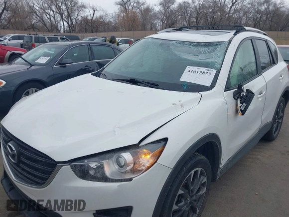 2016 Mazda CX-5 Grand Touring z VIN JM3KE2DY8G0885006, wystawiony jako IAAI lot #41615873 z przebiegiem 118 890 mil mil oraz . Historia ofert i sprzedaży dostępna na DreamBid. Obrazek 6.