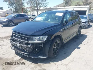 2021 Volkswagen Tiguan SE with VIN 3VV3B7AX0MM015825, listed as a IAAI auction lot 41955268 with 57,909 mi miles and . Bid and sale history available at DreamBid. Image 2.