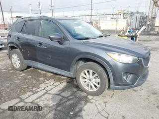 2014 Mazda CX-5 Touring z VIN JM3KE2CY0E0364781, wystawiony jako IAAI lot #40976627 z przebiegiem 153 195 mil mil oraz . Historia ofert i sprzedaży dostępna na DreamBid. Obrazek 1.