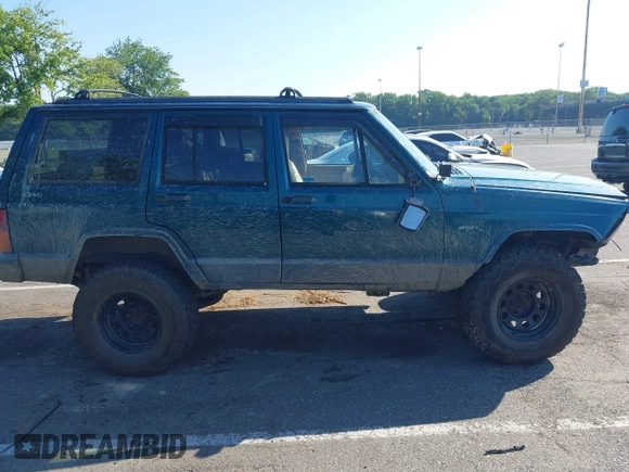 1995 Jeep Cherokee Sport z VIN 1J4FJ68S7SL623451, wystawiony jako IAAI lot #42581407 z przebiegiem 160 581 mil mil oraz . Historia ofert i sprzedaży dostępna na DreamBid. Obrazek 13.