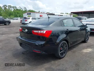 2014 Kia Rio LX with VIN KNADM4A33E6335499, listed as a IAAI auction lot 42123085 with 148,146 mi miles and . Bid and sale history available at DreamBid. Image 4.