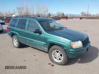1999 Jeep Grand Cherokee Limited z VIN 1J4GW68N4XC544651, wystawiony jako IAAI lot #41742346 z przebiegiem 94 904 mil mil oraz . Historia ofert i sprzedaży dostępna na DreamBid. Obrazek 1.