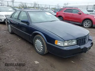 1993 Cadillac Seville Touring STS with VIN 1G6KY5297PU804313, listed as a IAAI auction lot 42001104 with 242,756 mi miles. Bid and sale history available at carsss.com. Image 1.