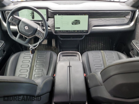 2022 Rivian R1S Launch Edition with VIN 7PDSGABL3NN000739, listed as a Copart auction lot 88127995 with 12,143 mi miles and Salvage Title. Bid and sale history available at DreamBid. Image 8.