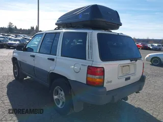 1996 Jeep Grand Cherokee Laredo z VIN 1J4GZ58Y5TC186403, wystawiony jako IAAI lot #41562270 z przebiegiem 205 797 mil mil oraz . Historia ofert i sprzedaży dostępna na DreamBid. Obrazek 3.