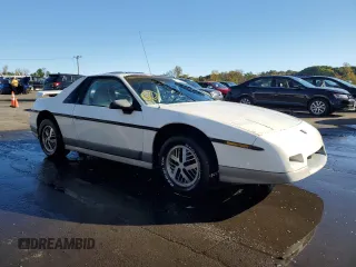 1985 Pontiac Fiero z VIN 1G2PG3796FP269589, wystawiony jako Copart lot #73338954 z przebiegiem 34 364 mil mil oraz Czysty tytuł • Clean title. Historia ofert i sprzedaży dostępna na DreamBid. Obrazek 4.