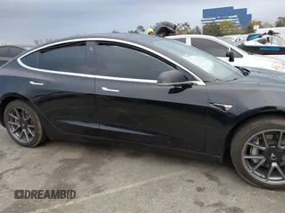 2019 Tesla Model 3 Mid Range with VIN 5YJ3E1EA6KF361808, listed as a IAAI auction lot 41767241 with 96,200 mi miles and . Bid and sale history available at carsss.com. Image 13.