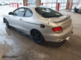 2001 Hyundai Tiburon with VIN KMHJG25FX1U237304, listed as a IAAI auction lot 41715407 with 257,564 mi miles. Bid and sale history available at carsss.com. Image 3.