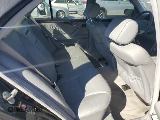 2000 Mercedes-Benz E-Class with VIN WDBJF70JXYB091085, listed as a Copart auction lot 77136484 with 185,429 mi miles and Salvage Title. Bid and sale history available at carsss.com. Image 10.
