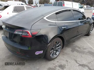 2019 Tesla Model 3 Mid Range with VIN 5YJ3E1EA6KF361808, listed as a IAAI auction lot 41767241 with 96,200 mi miles and . Bid and sale history available at carsss.com. Image 4.