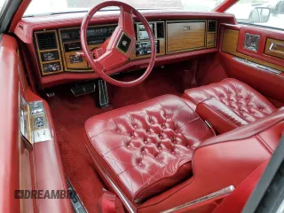 1985 Cadillac Eldorado z VIN 1G6EL5782FE634074, wystawiony jako Copart lot #44520964 z przebiegiem 74 425 mil mil oraz Szkody całkowita. Historia ofert i sprzedaży dostępna na DreamBid. Obrazek 8.