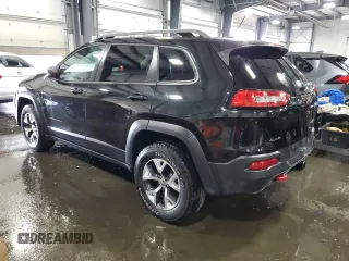 2014 Jeep Cherokee Trailhawk with VIN 1C4PJMBSXEW187981, listed as a Copart auction lot 56711885 with 157,317 mi miles and Salvage title. Bid and sale history available at DreamBid. Image 2.