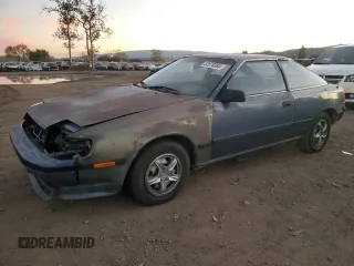 1988 Toyota Celica z VIN JT2ST67L3J7233214, wystawiony jako Copart lot #82878384 z przebiegiem 259 637 mil mil oraz Szkody całkowita. Historia ofert i sprzedaży dostępna na DreamBid. Obrazek 1.