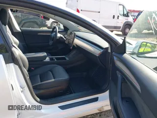 2023 Tesla Model 3 with VIN 5YJ3E1EA3PF617460, listed as a IAAI auction lot 42154401 with 9,578 mi miles and . Bid and sale history available at DreamBid. Image 5.
