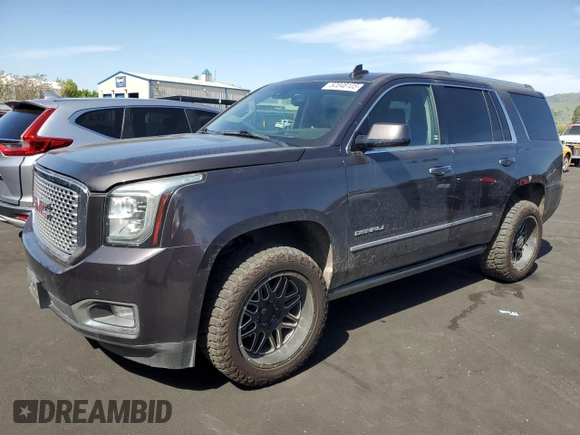 2015 GMC Yukon Denali with VIN 1GKS2CKJ8FR596848, listed as a Copart auction lot 52048105 with 129,935 mi miles and Salvage Title. Bid and sale history available at carsss.com. Image 1.