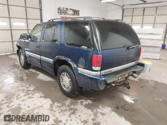 1999 GMC Jimmy SLE z VIN 1GKDT13W8X2534672, wystawiony jako IAAI lot #41562434 z przebiegiem 240 145 mil mil oraz . Historia ofert i sprzedaży dostępna na DreamBid. Obrazek 3.