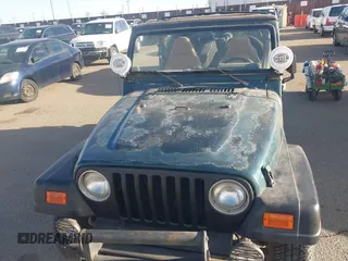 1997 Jeep Wrangler SE with VIN 1J4FY29PXVP409498, listed as a IAAI auction lot 41818698 with 150,086 mi miles. Bid and sale history available at carsss.com. Image 6.