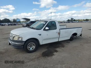 1999 Ford F-150 with VIN 1FTRF17W9XNB67119, listed as a Copart auction lot 79197414 with Not provided miles and Salvage title. Bid and sale history available at DreamBid. Image 1.