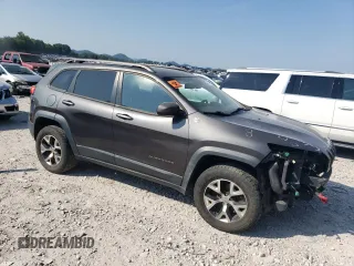 2014 Jeep Cherokee Trailhawk with VIN 1C4PJMBS1EW304718, listed as a Copart auction lot 64105485 with 151,315 mi miles and Salvage title. Bid and sale history available at DreamBid. Image 4.