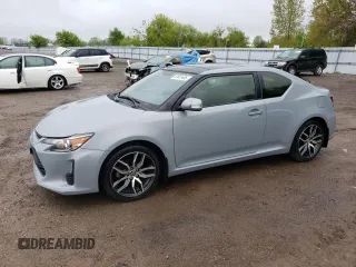 2014 Scion tC z VIN JTKJF5C7XE3086652, wystawiony jako Copart lot #57451485 z przebiegiem 216 577 mil mil oraz Szkoda całkowita • Salvage title. Historia ofert i sprzedaży dostępna na DreamBid. Obrazek 1.