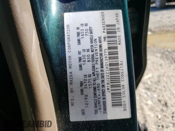 1999 Mazda Protege DX with VIN JM1BJ2223X0139775, listed as a Copart auction lot 54338455 with 63,198 mi miles and Salvage Title. Bid and sale history available at DreamBid. Image 12.