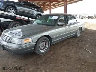 1999 Ford Crown Victoria LX with VIN 2FAFP74W9XX233325, listed as a IAAI auction lot 40934834 with 176,845 mi miles. Bid and sale history available at carsss.com. Image 17.