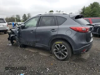 2016 Mazda CX-5 Grand Touring z VIN JM3KE2DY9G0687261, wystawiony jako Copart lot #52865415 z przebiegiem Nie podano mil oraz Szkoda całkowita • Salvage title. Historia ofert i sprzedaży dostępna na DreamBid. Obrazek 2.