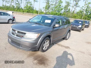 2013 Dodge Journey SE z VIN 3C4PDCAB5DT518019, wystawiony jako IAAI lot #42409340 z przebiegiem 174 339 mil mil oraz . Historia ofert i sprzedaży dostępna na DreamBid. Obrazek 2.