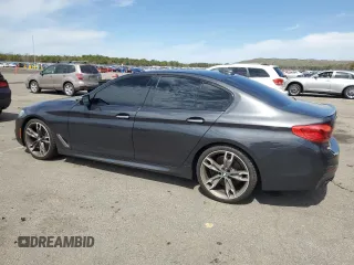 2018 BMW 5 Series M550i xDrive with VIN WBAJB9C57JB286734, listed as a Copart auction lot 52711235 with 127,450 mi miles and Salvage title. Bid and sale history available at DreamBid. Image 2.
