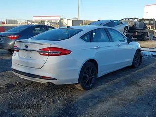 2018 Ford Fusion SE z VIN 3FA6P0H77JR108212, wystawiony jako IAAI lot #41208435 z przebiegiem 68 825 mil mil oraz . Historia ofert i sprzedaży dostępna na DreamBid. Obrazek 4.