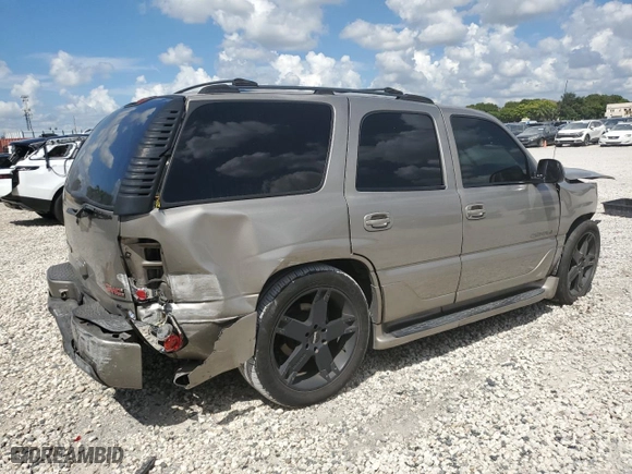 2002 GMC Yukon Denali with VIN 1GKEK63U12J154624, listed as a Copart auction lot 73827304 with 165,518 mi miles and Salvage Title. Bid and sale history available at carsss.com. Image 3.
