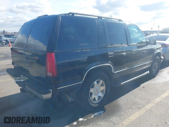 1997 GMC Yukon with VIN 1GKEK13R3VJ759103, listed as a IAAI auction lot 41726127 with 218,500 mi miles. Bid and sale history available at carsss.com. Image 4.