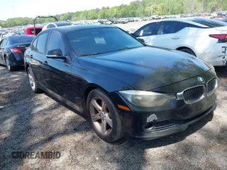 2014 BMW 3 Series 320i with VIN WBA3B1C56EK131849, listed as a IAAI auction lot 42018005 with 215,765 mi miles. Bid and sale history available at carsss.com. Image 1.