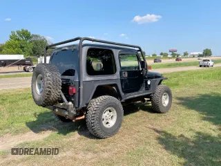 1999 Jeep Wrangler Sahara with VIN 1J4FY49S5XP496486, listed as a Copart auction lot 54989365 with 128,498 mi miles and Clean Title. Bid and sale history available at carsss.com. Image 4.