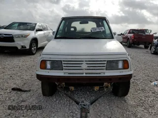 1994 Suzuki Sidekick z VIN 2S3TA01C8R6408593, wystawiony jako Copart lot #65011514 z przebiegiem 248 814 mil mil oraz Tytuł czysty. Historia ofert i sprzedaży dostępna na DreamBid. Obrazek 5.