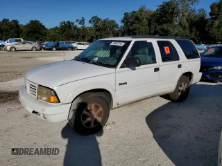 1999 Oldsmobile Bravada z VIN 1GHDT13W1X2704151, wystawiony jako Copart lot #76802764 z przebiegiem 155 630 mil mil oraz Szkody całkowita. Historia ofert i sprzedaży dostępna na DreamBid. Obrazek 1.