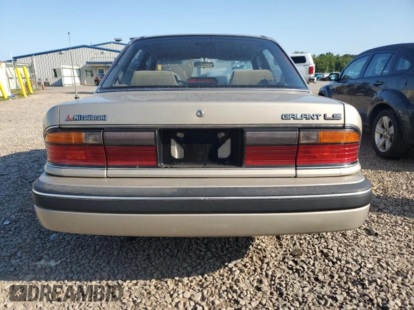1989 Mitsubishi Galant with VIN JA3BR56V1KZ052149, listed as a Copart auction lot 69987544 with 74,232 mi miles and Salvage Title. Bid and sale history available at DreamBid. Image 6.