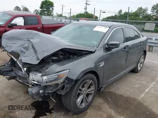 2015 Ford Taurus SEL z VIN 1FAHP2E81FG163058, wystawiony jako IAAI lot #42279778 z przebiegiem 127 957 mil mil oraz . Historia ofert i sprzedaży dostępna na DreamBid. Obrazek 2.