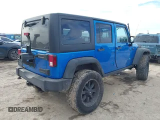 2015 Jeep Wrangler Unlimited Rubicon with VIN 1C4BJWFG5FL558348, listed as a IAAI auction lot 41460025 with 106,012 mi miles. Bid and sale history available at carsss.com. Image 4.