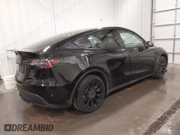 2021 Tesla Model Y Long Range with VIN 5YJYGAEE5MF305655, listed as a IAAI auction lot 41860993 with 50,750 mi miles. Bid and sale history available at carsss.com. Image 4.
